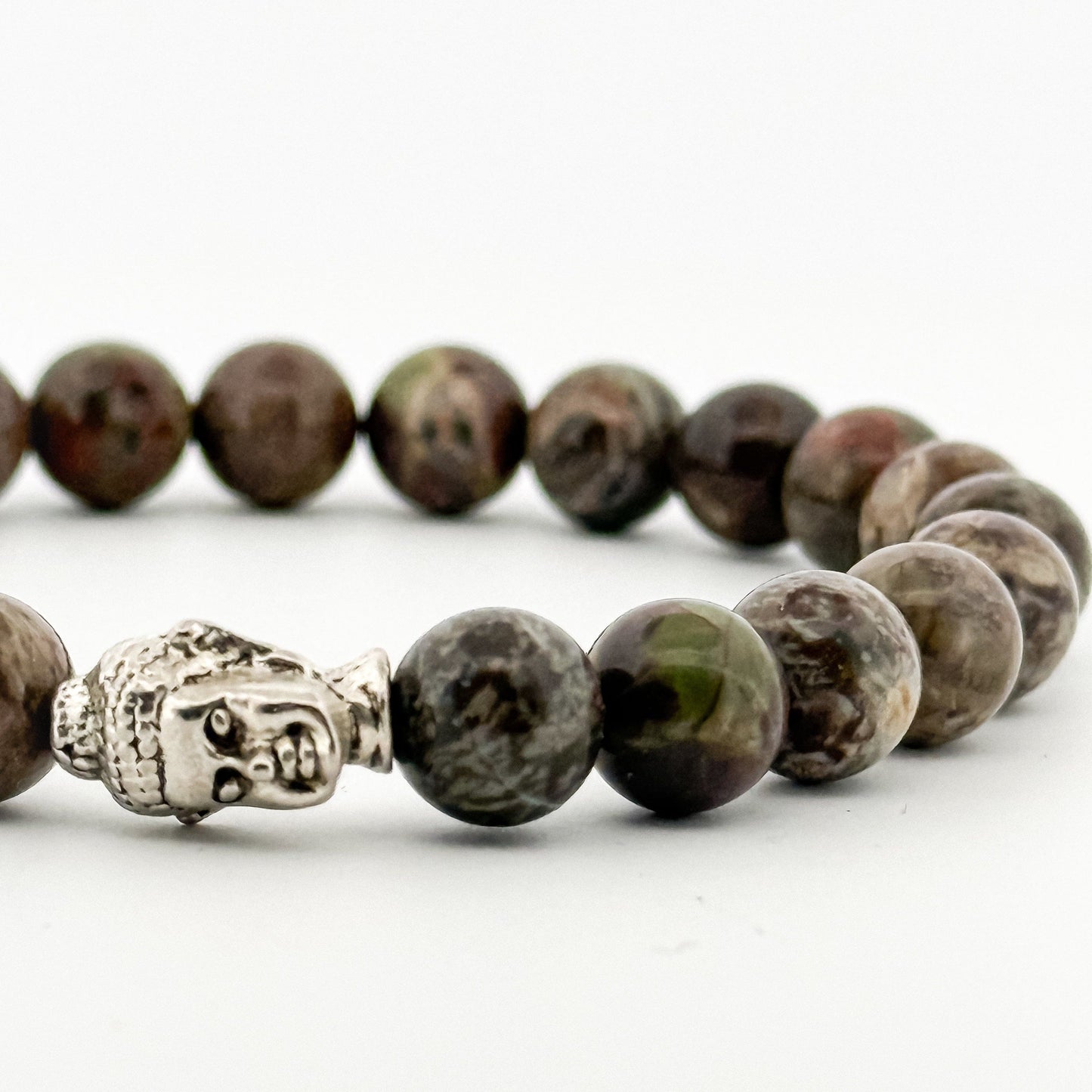 Beaded bracelet with a Buddha charm on a white background