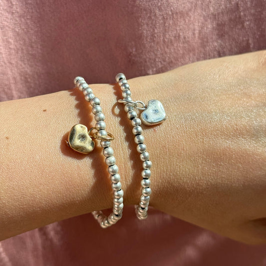 Set of Silver bead bracelets with Heart Charm on a wrist