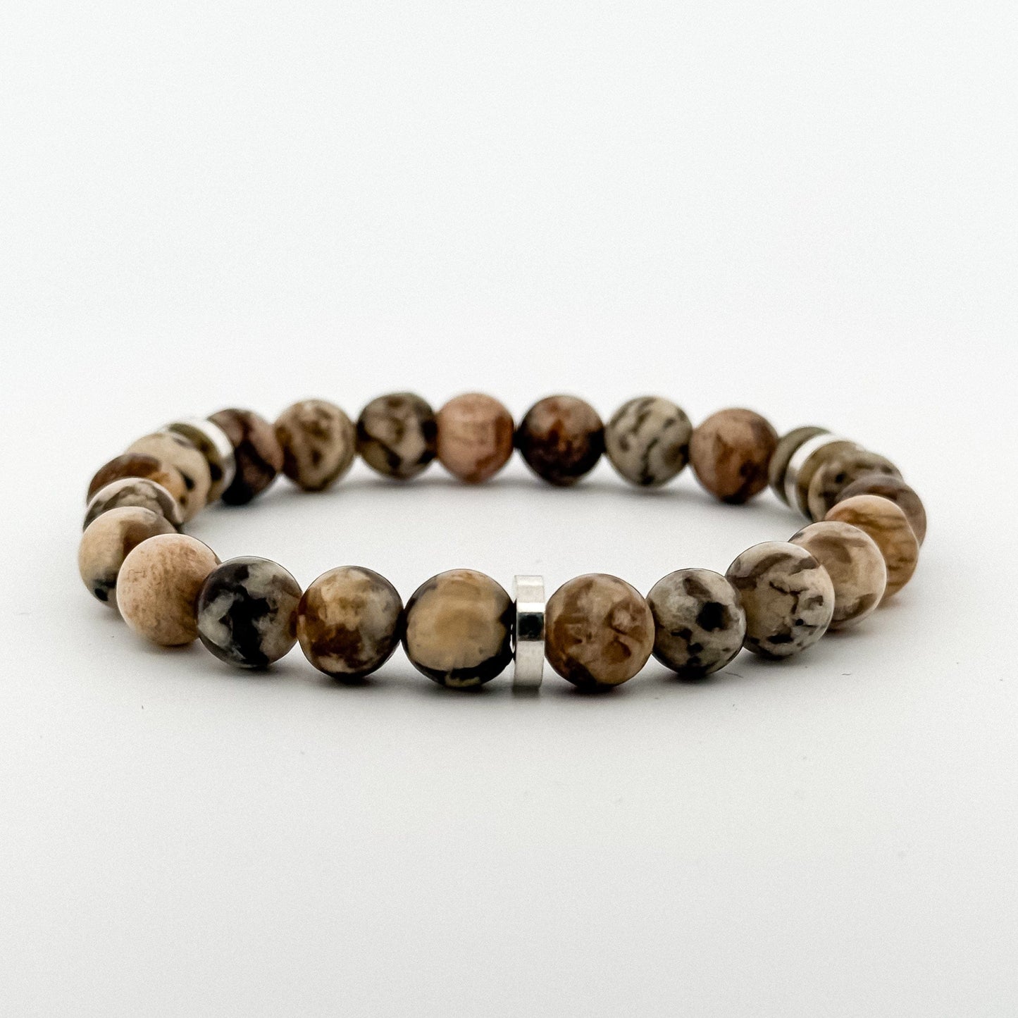 Beaded bracelet with brown and beige stones on a white background