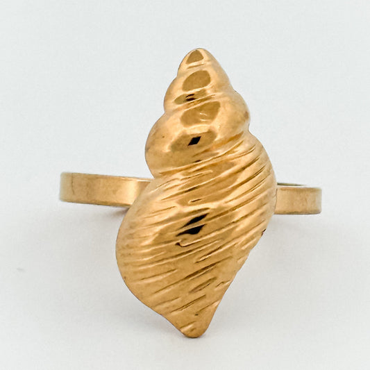 Gold shell-shaped ring on a white background