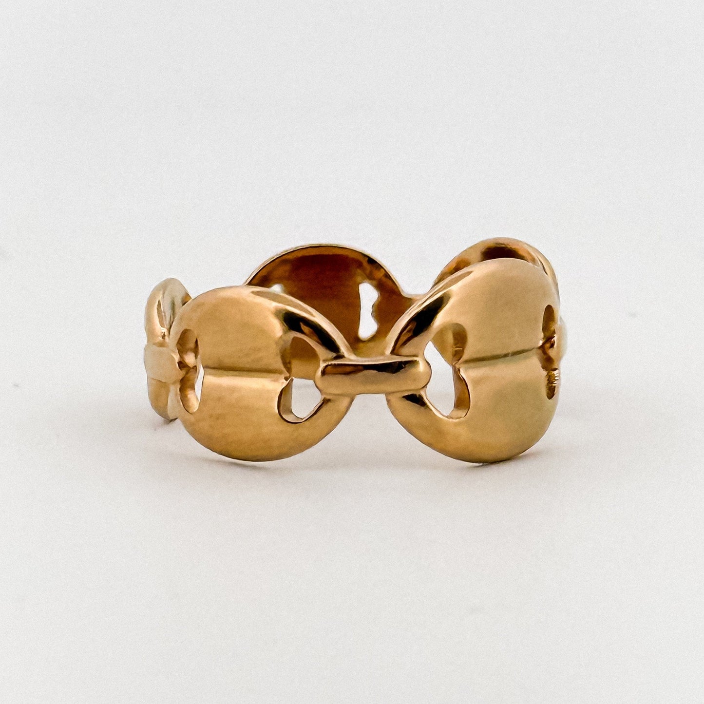 Gold ring with a unique design on a white background