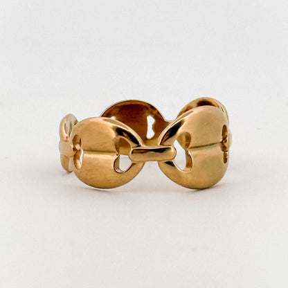 Gold ring with a unique design on a white background
