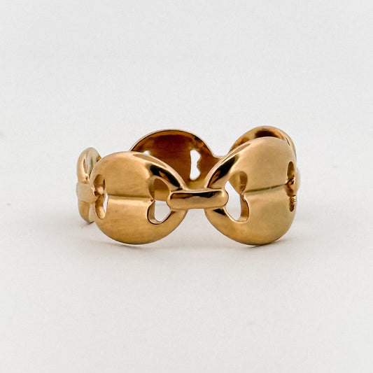 Gold ring with a unique design on a white background