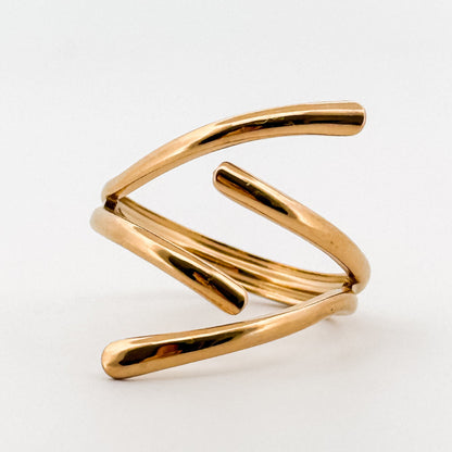 Gold spiral ring on a white background