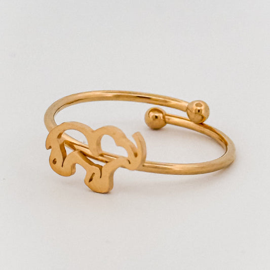 Gold bracelet on a light gray background