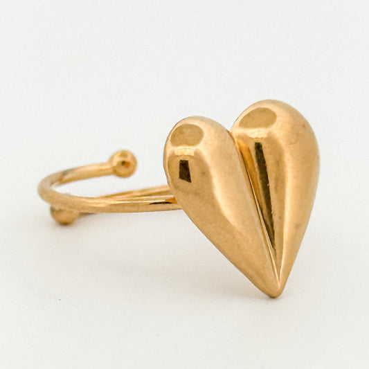 Gold heart-shaped ring on a white background