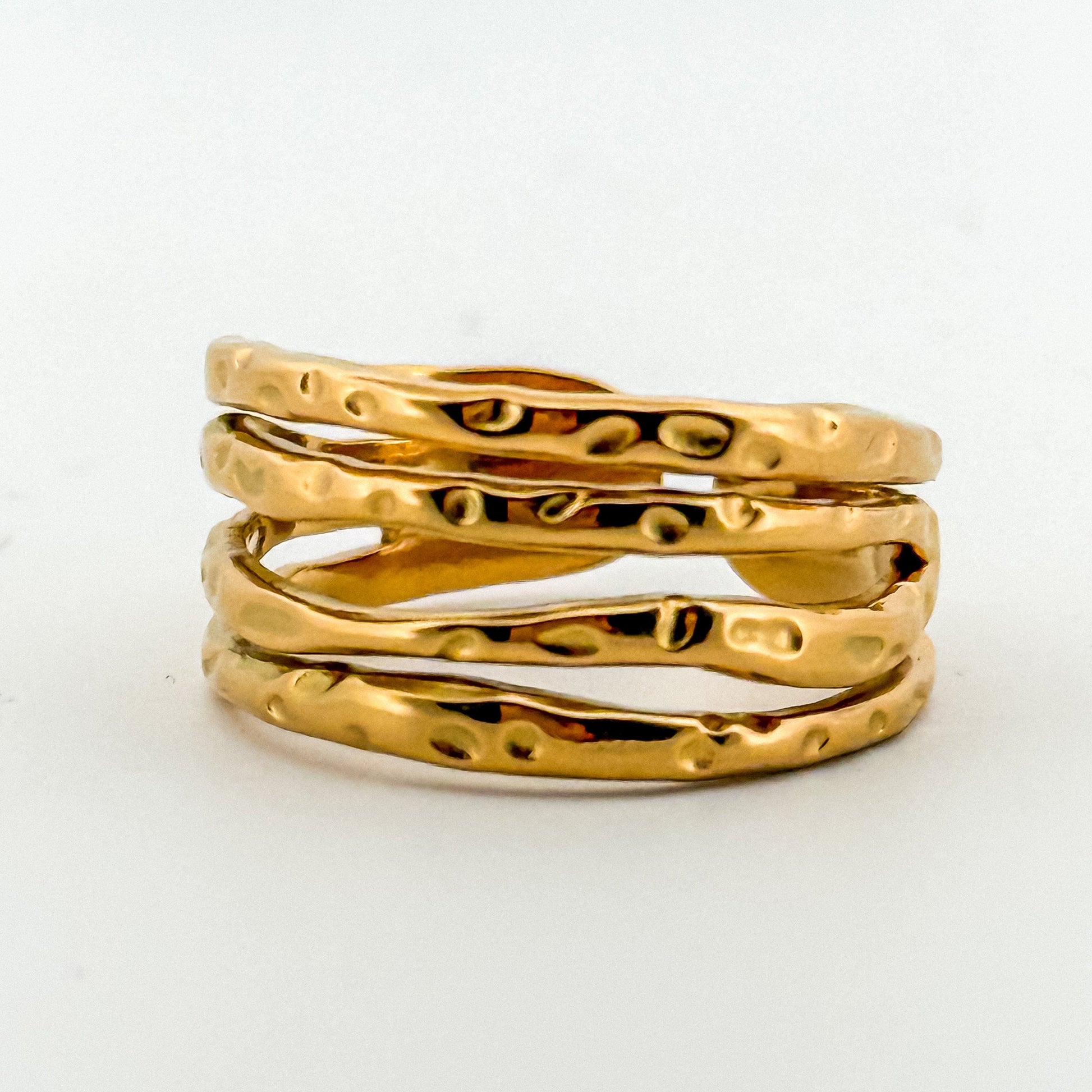 Three gold rings stacked on a white background