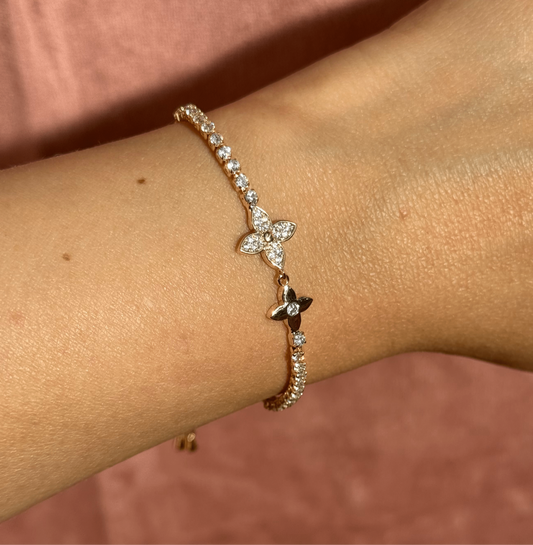 Gold bracelet with flower lys charm connector and cubic zirconia stones