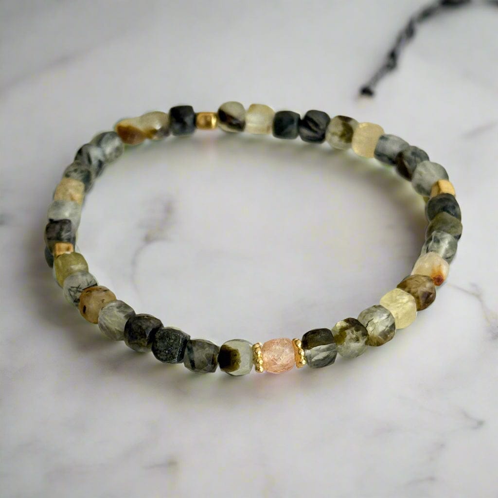 Beaded bracelet with multicolored stones on a textured surface