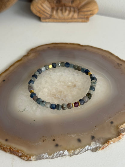Bracelet with small stones on a natural stone surface