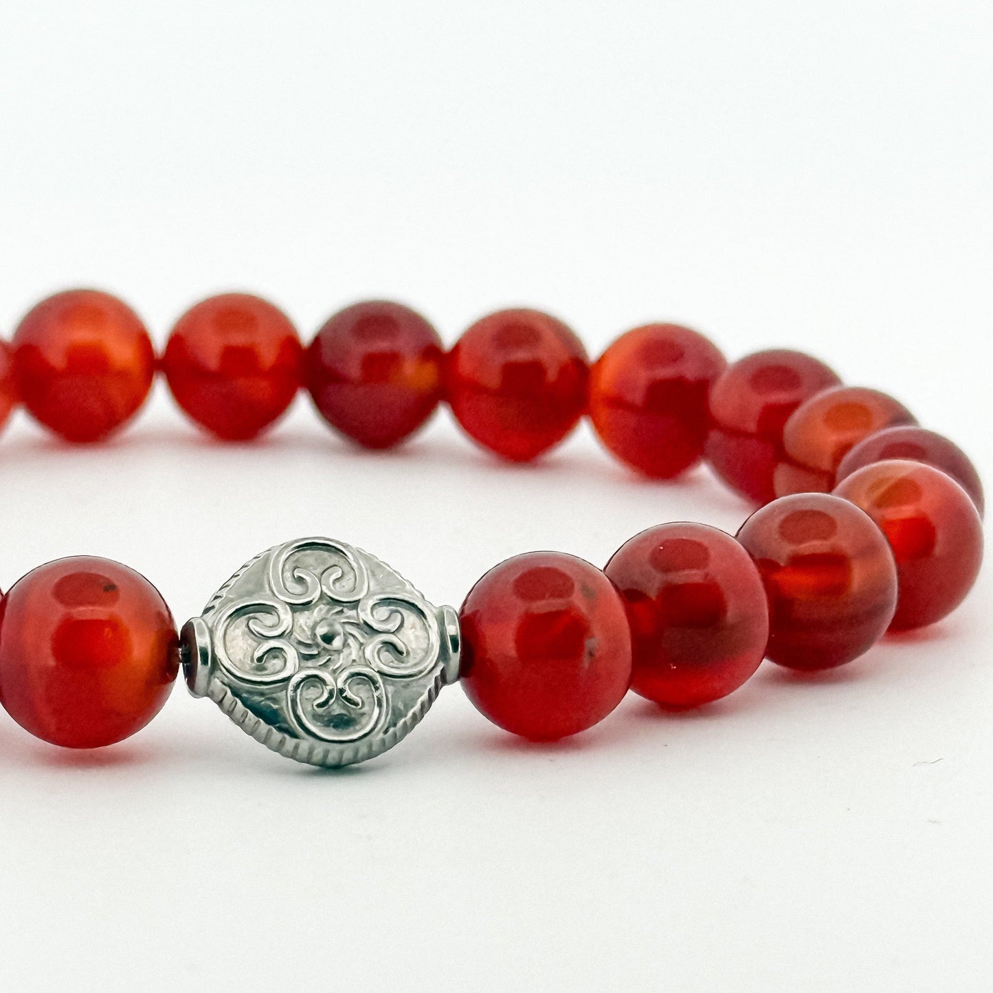 Bracelet with red carnelian stone beads and a silver engraved bead