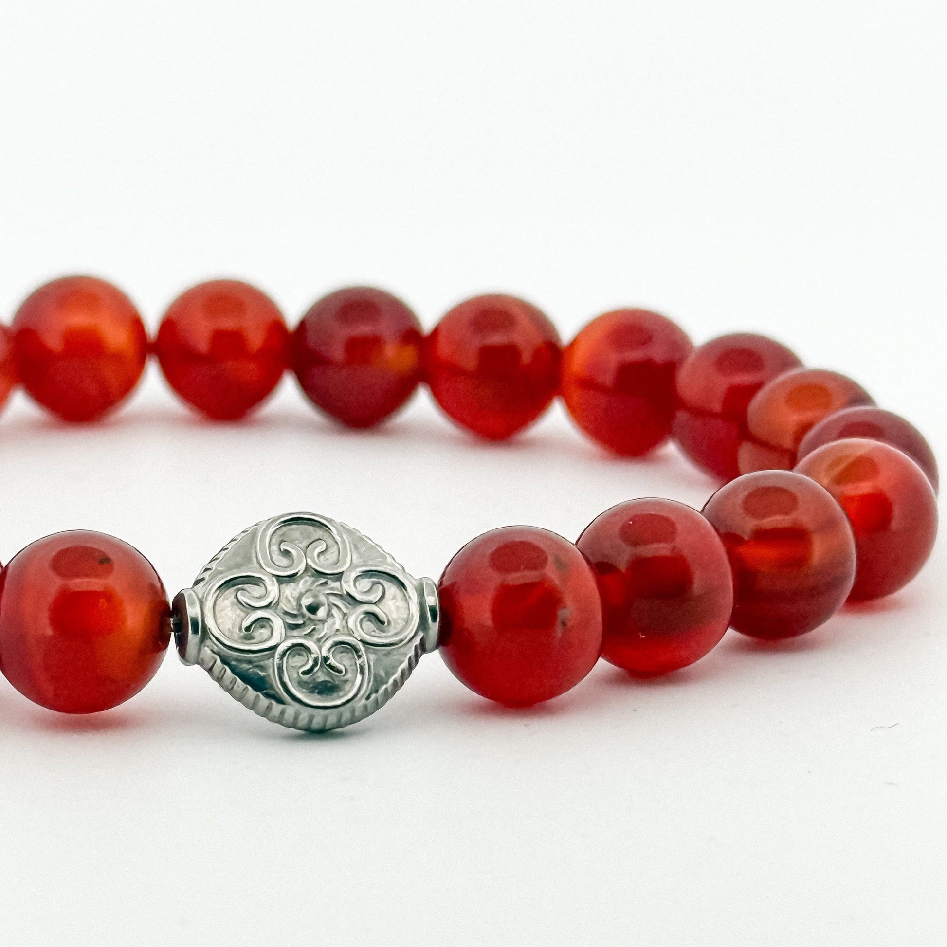 Bracelet with red carnelian stone beads and a silver engraved bead