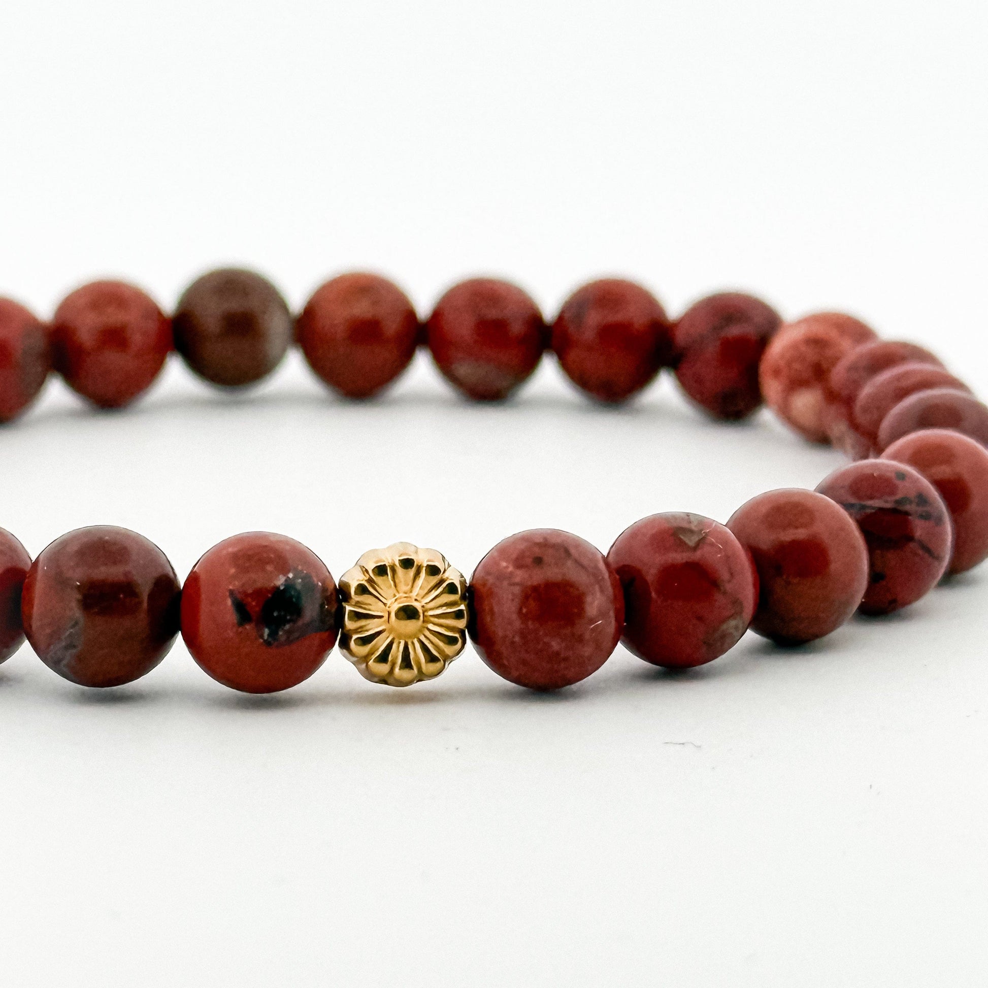 Red jasper stone beaded bracelet with a gold sunflower bead
