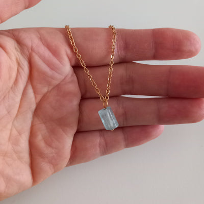 Aquamarine, lucky stone, gold chain necklace in my hand